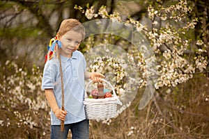 Cute preschool child, whipping his sister on Easter with twig, braided whip made from pussy willow, traditional symbol of Czech