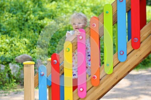 Cute preschooler girl playing outdoors in the park