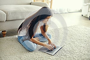 Cute preteen 12s girl use laptop sit on floor
