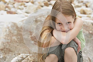 Cute Preteen Girl Sitting On Rock