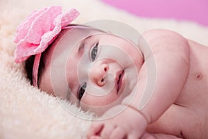 Cute, pretty, happy, chubby baby girl portrait, without clothes, or, on a fluffy blanket.