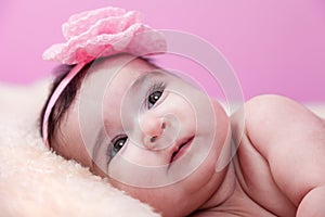 Cute, pretty, happy, chubby baby girl portrait smiling. Lying or on fluffy blanket.