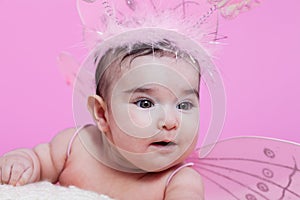 Cute, pretty, happy, chubby and smiling baby girl portrait, with pink butterfly wings