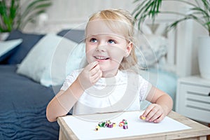 Cute pretty little girl eats candies