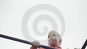 Cute pretty Preschool children climb stairs on playground. Little boy in jamper laughing and having fun, swinging on