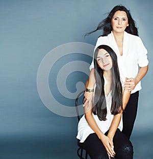 cute pretty teen daughter with mature mother hugging, fashion style brunette, lifestyle people concept