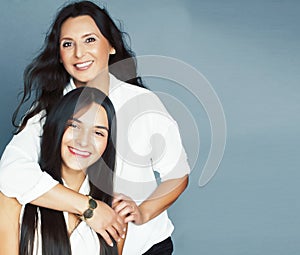 cute pretty teen daughter with mature mother hugging, fashion style brunette, lifestyle people concept