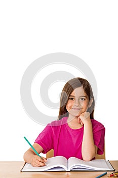 Cute pupil working at her desk