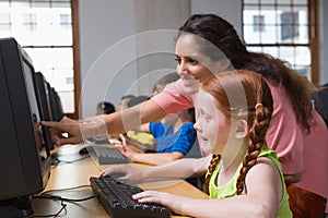 Cute pupils in computer class with teacher