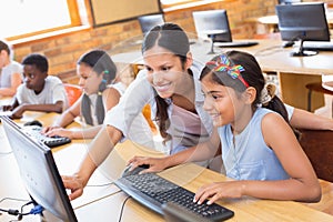 Cute pupils in computer class with teacher