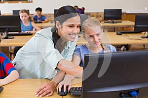 Cute pupils in computer class with teacher