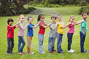 Cute pupils standing on the grass outside