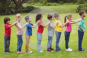 Cute pupils standing on the grass outside