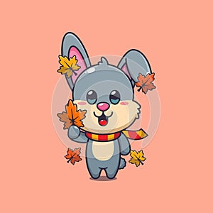 Cute rabbit holding autumn leaf.