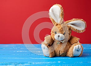 Cute rabbit toy on a red background