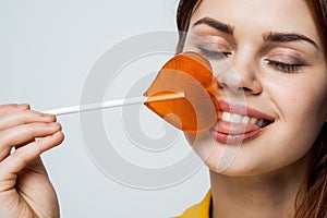 cute red-haired woman with lollipop in her mouth glamor closeup