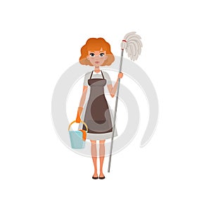 Cute red-haired woman standing and holding mop and bucket. Cleaning service. House maid dressed in dress, apron and