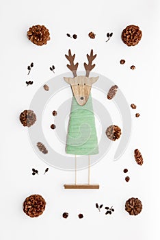 Cute reindeer chrismas decoration flat on white background. Xmas composition with pine cones and a reindeer. photo