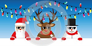 Cute reindeer santa and snowman cartoon with sunglasses and christmas fairy lights