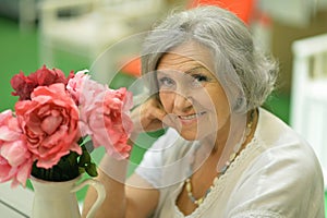 Cute retired woman with flowers