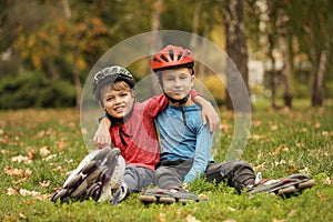 Cute roller skaters sitting on grass