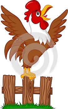 Cute rooster cartoon crowing on the fence photo