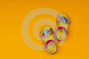 Cute sandals for kids on yellow background. Little girl sandals