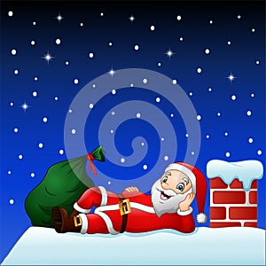 Cute santa claus on the house roof chimney with bag of gifts