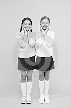 Cute school girls classmates. First school day. Sisterhood and friendship. Cheerful mood concept. School friendship