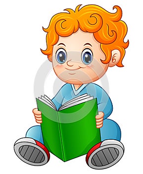 Cute schoolboy reading a book