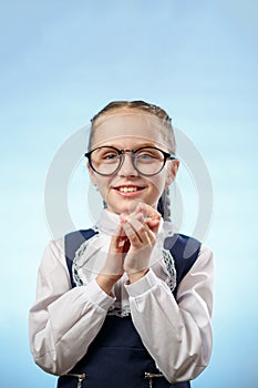 Cute Schoolgirl In Glasses Smile Implore Gesture photo