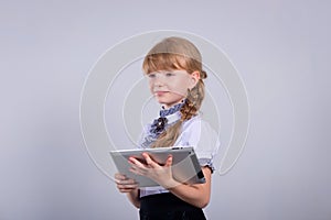 Cute schoolgirl with a laptop