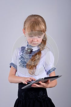 Cute schoolgirl with a laptop