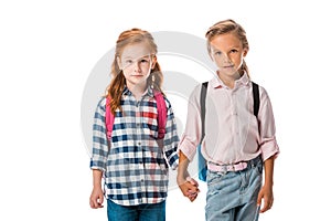 cute schoolkids with backpack holding hands isolated on white.