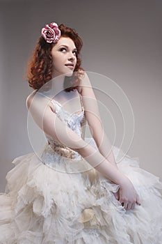 Cute and Sensual Caucasian Red-Haired Female in Tailored Wedding Dress.