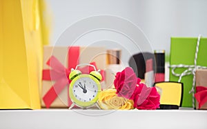 Cute shopping bag, make up set, gifts, alarm clock and roses on