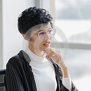 Cute and short hair businesswoman wearing eyesglasses in office