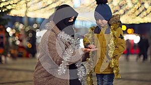 Cute shy little boy gesturing high-five with Middle Eastern woman smiling turning looking at camera. Portrait of happy