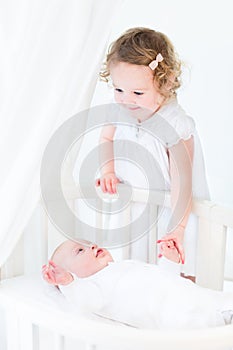 Cute siblings, little toddler girl and newborn baby