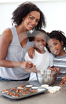 Cute siblings with their mother making biscuits