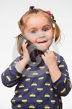 Cute and sincere beautiful girl talking on the phone, portrait of girl 3-4 years