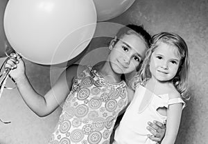 Cute sisters with balloons