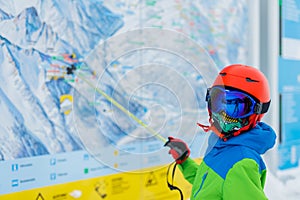 Cute skier boy in a winter ski resort.