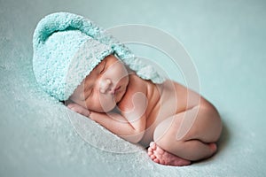 Newborn baby asian boy sleeping at blue background photo