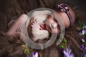 Infant baby girl sleeping at background. Newborn and mothercare concept photo