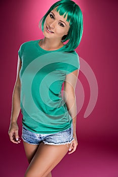 Cute slender young woman with green hair