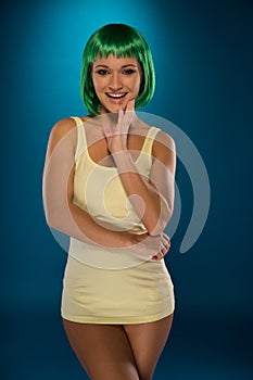 Cute slender young woman with green hair