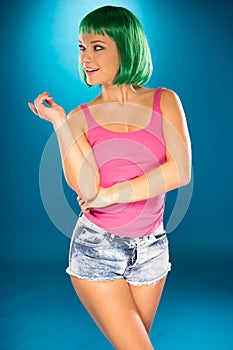 Cute slender young woman with green wig