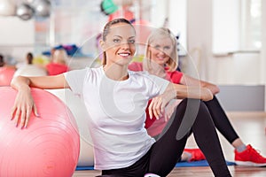 Cute slim girls are exercising in fitness center