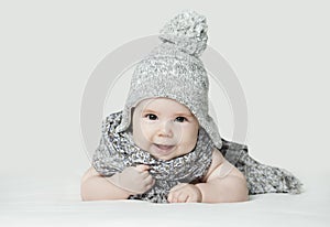 Cute small baby in knitted hat, portrait. Happy child